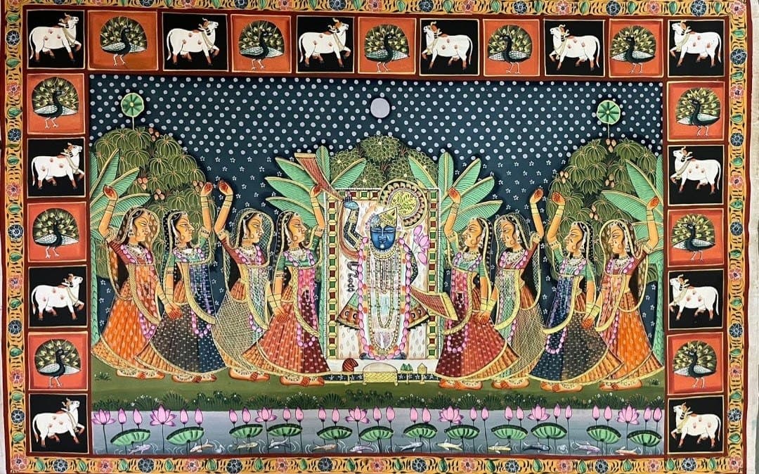 A Pichwai painting of Shrinathji at the centre, flanked by gopis, with a border of white cows.